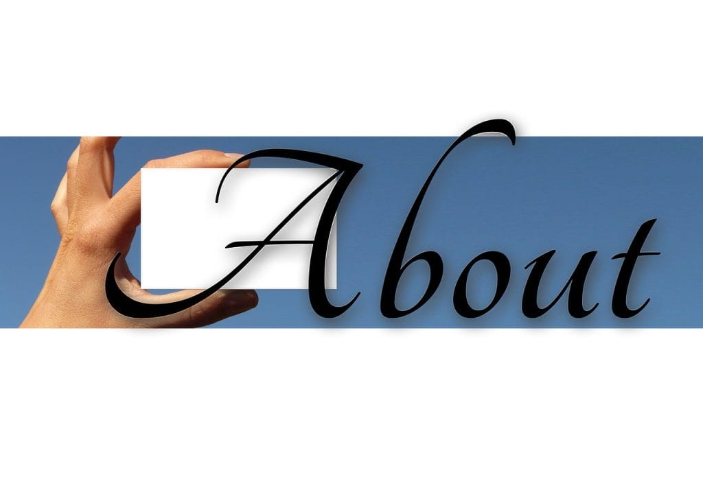 Word “About” written on a card, representing introduction or information section.